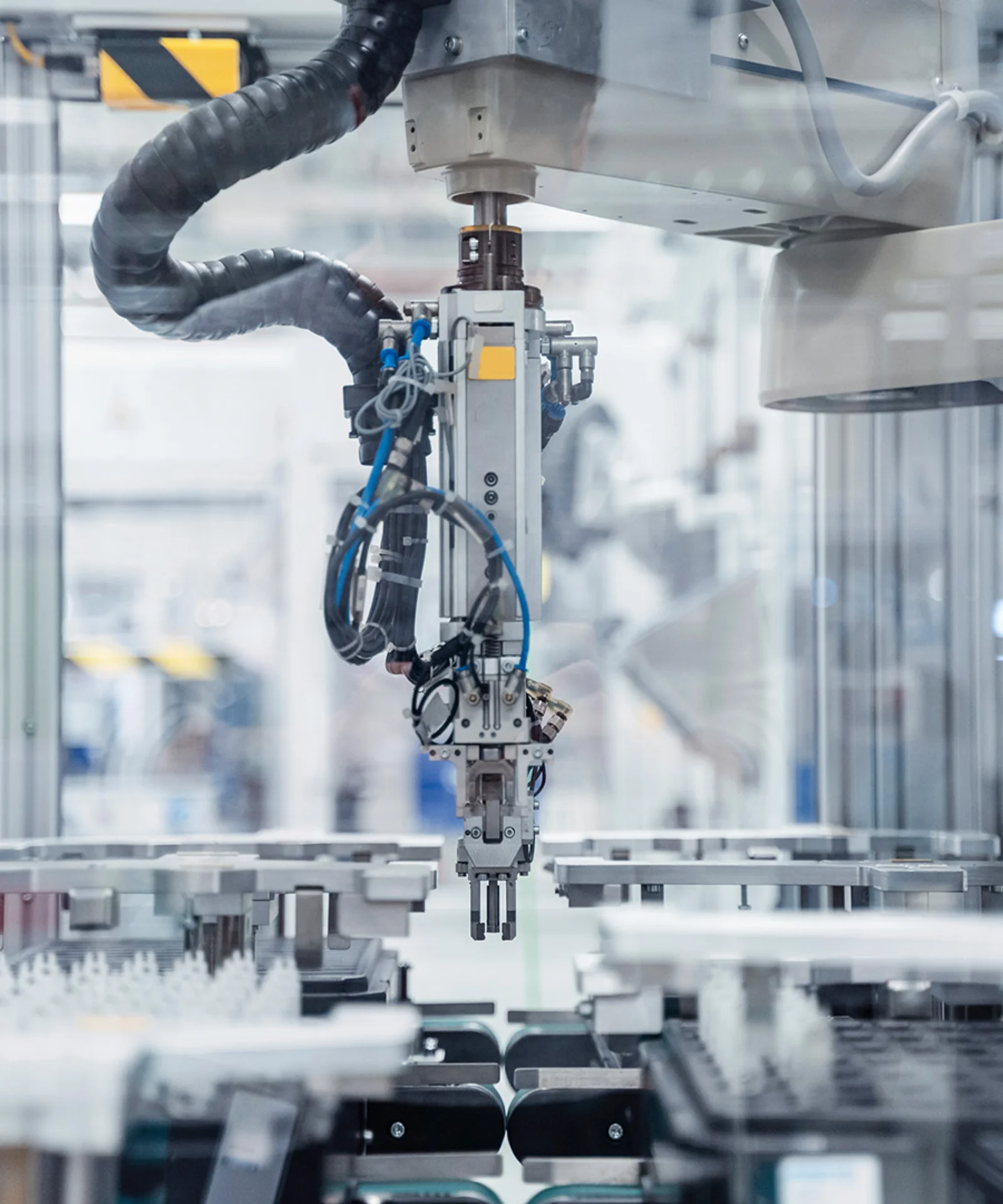 Robotic arm in an automated production line in a modern factory setting.