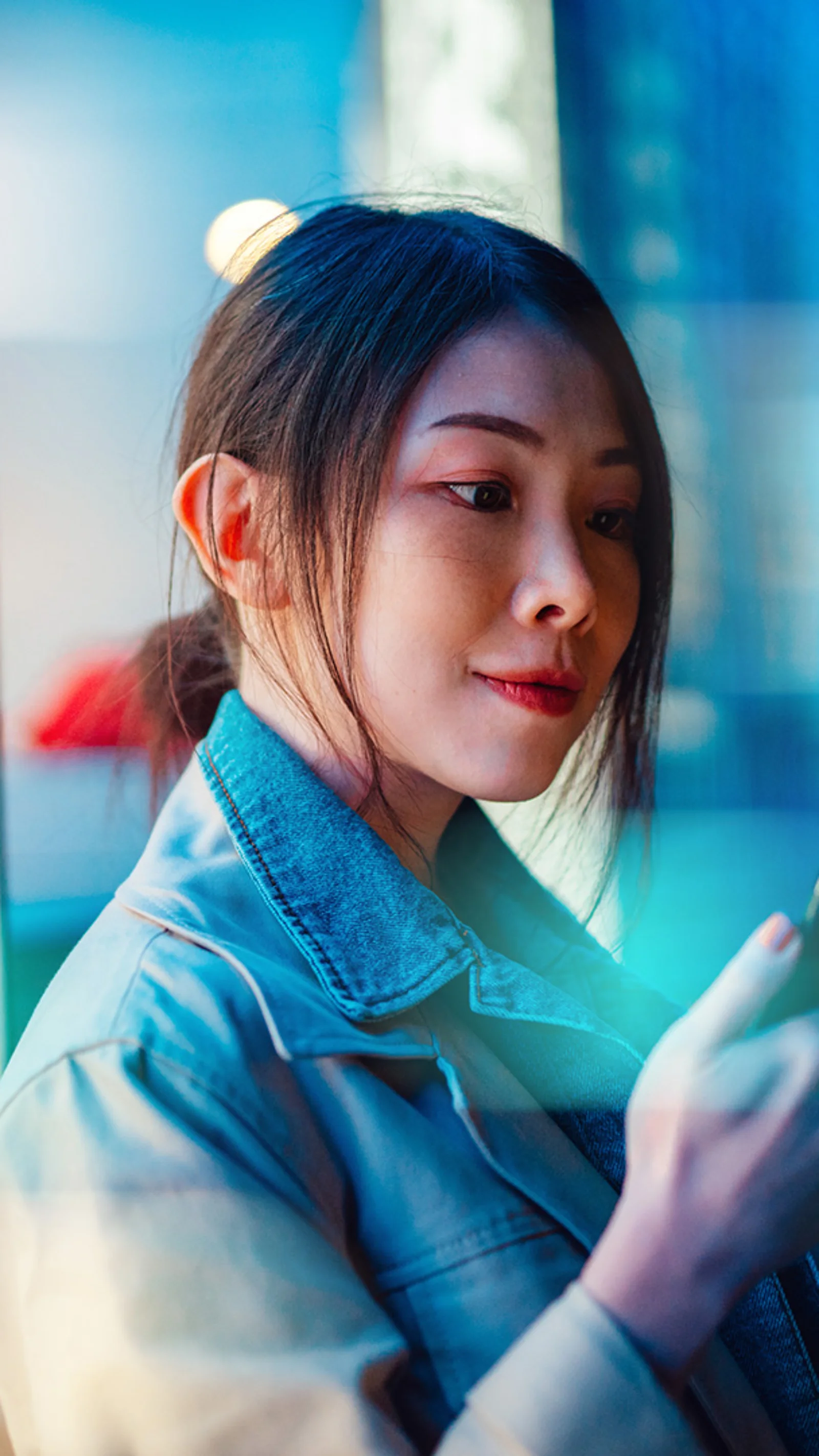 Interoperability: The Key to Unlocking the Potential of Regulated Digital Payments A woman using her smartphone, symbolizing the seamless integration and interoperability of digital payment systems in the regulated financial ecosystem.
