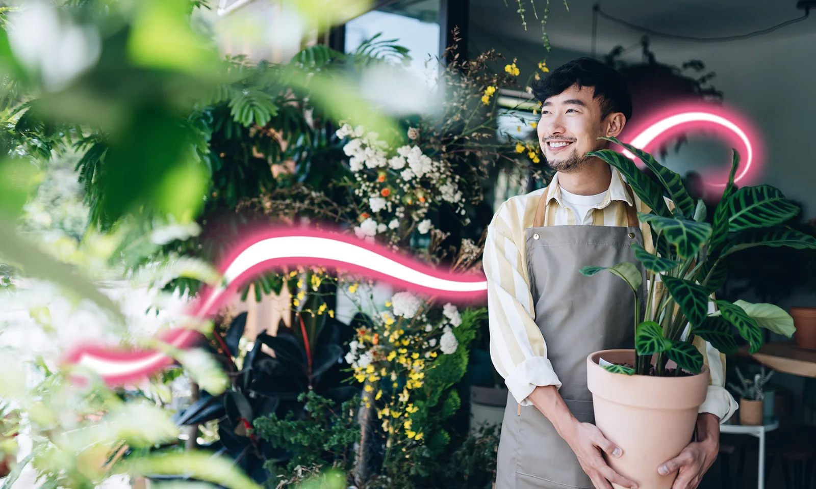 A smiling florist holding a potted plant in a lush green shop, symbolising growth and innovation in corporate banking digitalisation. A glowing light trail represents seamless digital transformation.