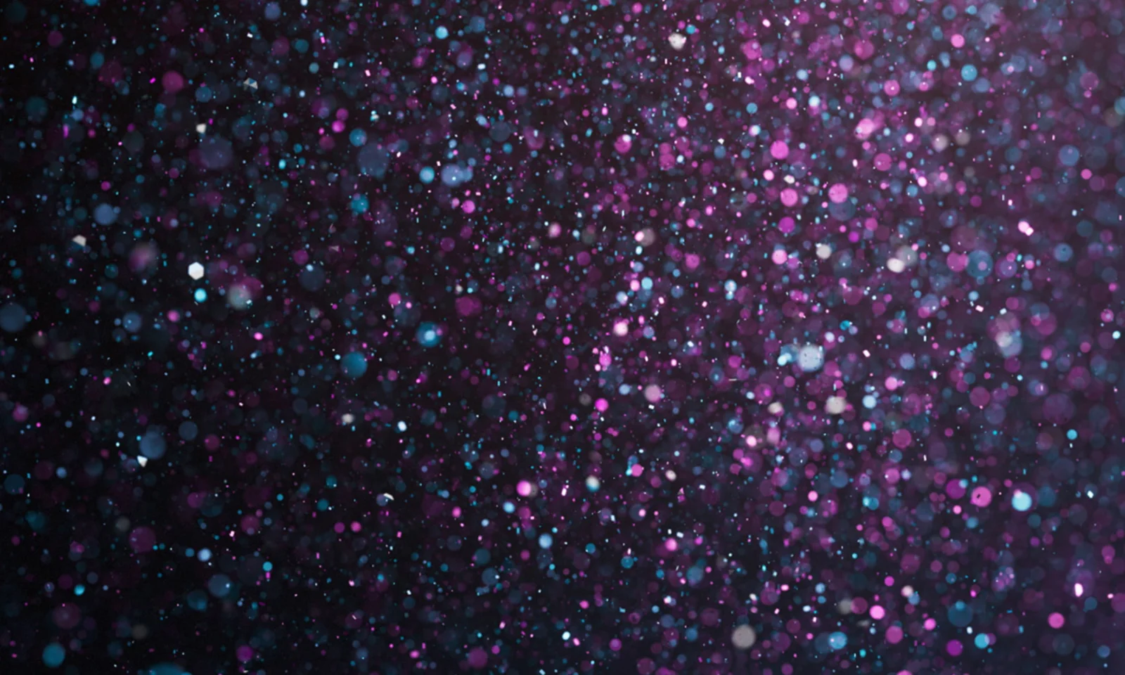 Celebrating GFT's Award-Winning Innovations Abstract image with a left-aligned focus, featuring a glittering background of purple, blue, and white sparkles. The design symbolises GFT's numerous awards and achievements.