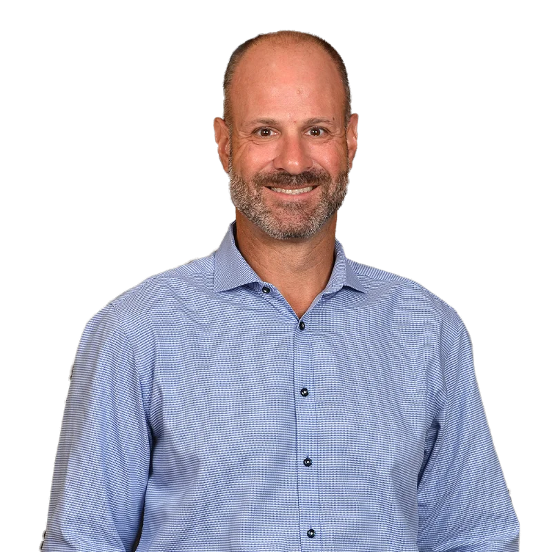 Michael Pizzo Portrait of Michael Pizzo wearing a light blue patterned shirt, smiling with a relaxed and approachable expression.